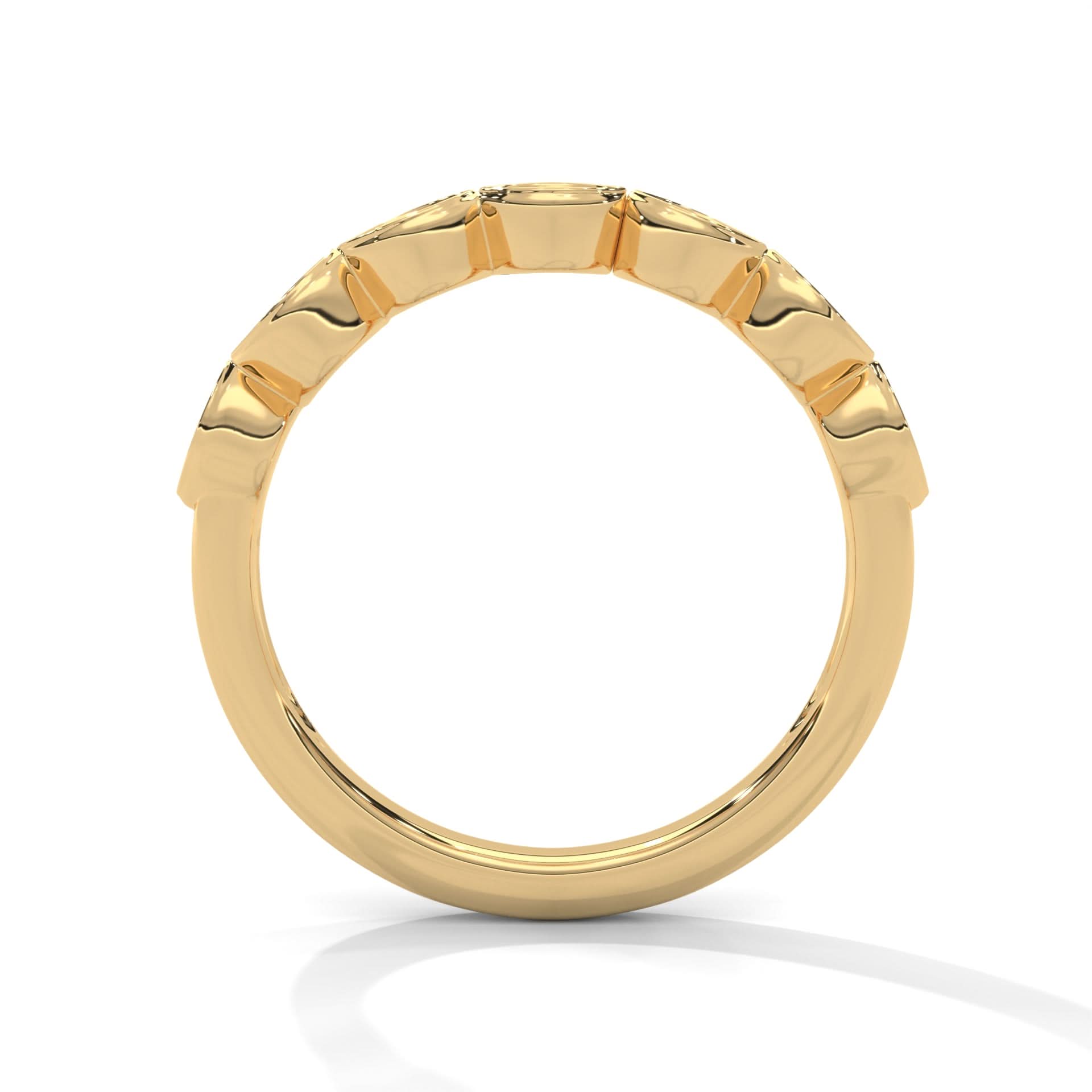 Gold ring with a textured band on a white background