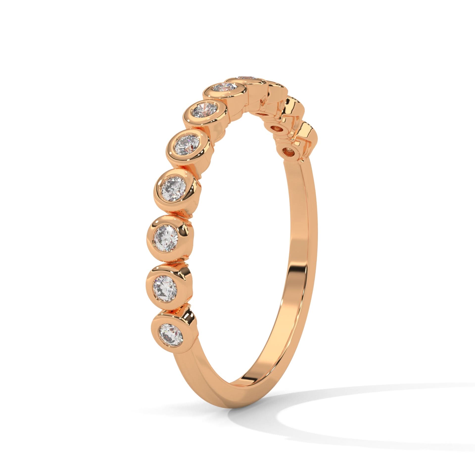 Rose gold ring with Bezel set diamonds on a white background