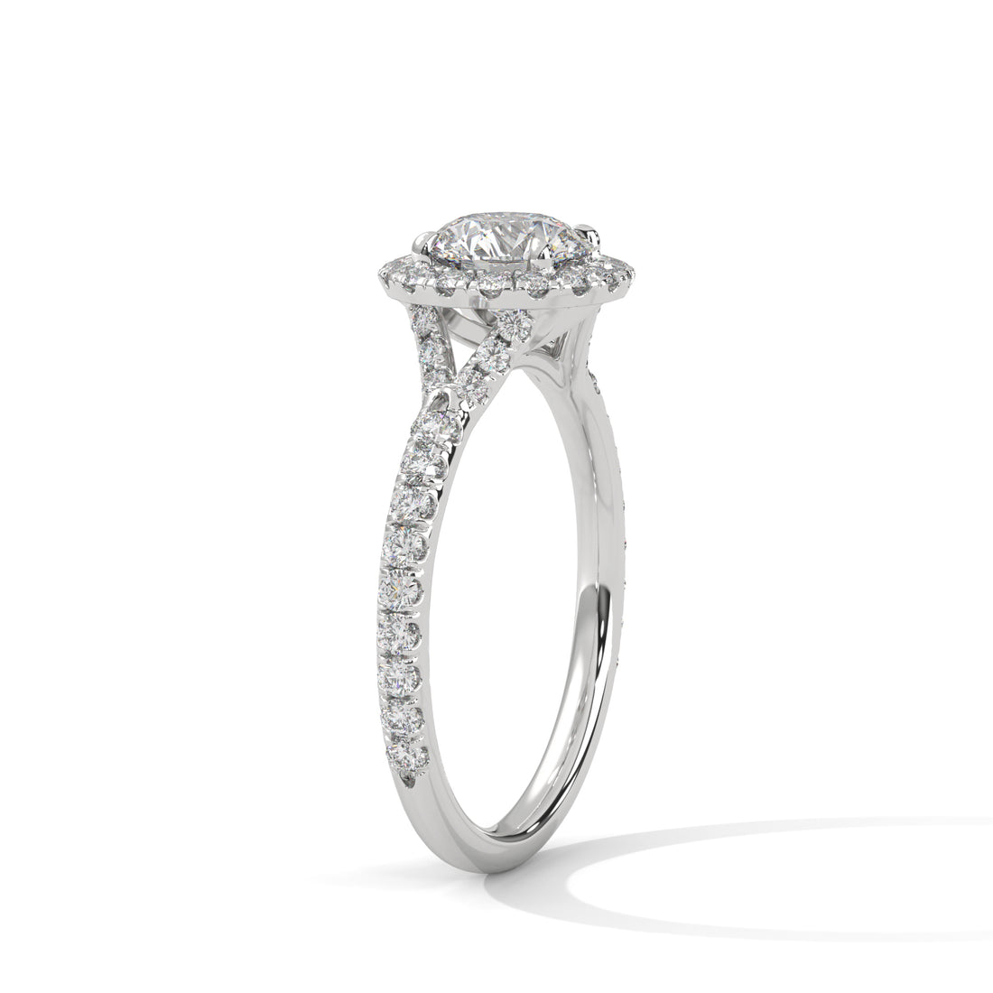 Diamond ring with a halo setting on a white background