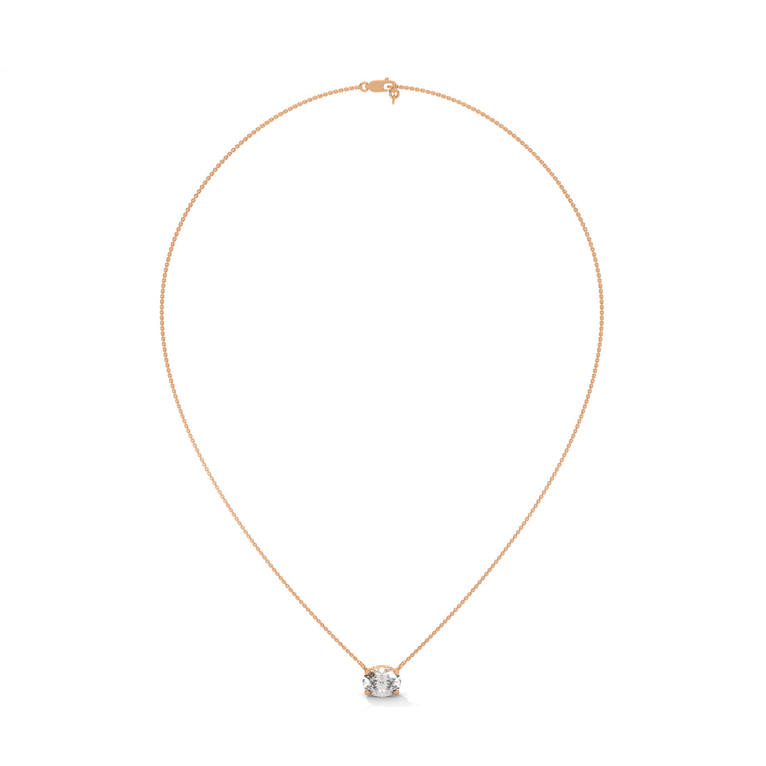 Gold necklace with a small round pendant on a white background