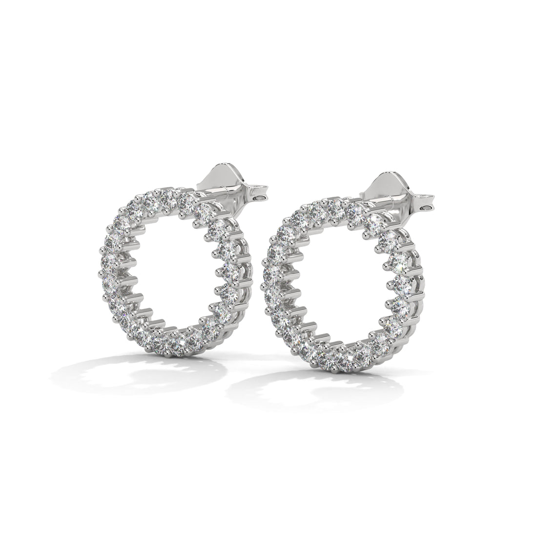 Pair of silver hoop earrings with clear gemstones on a white background