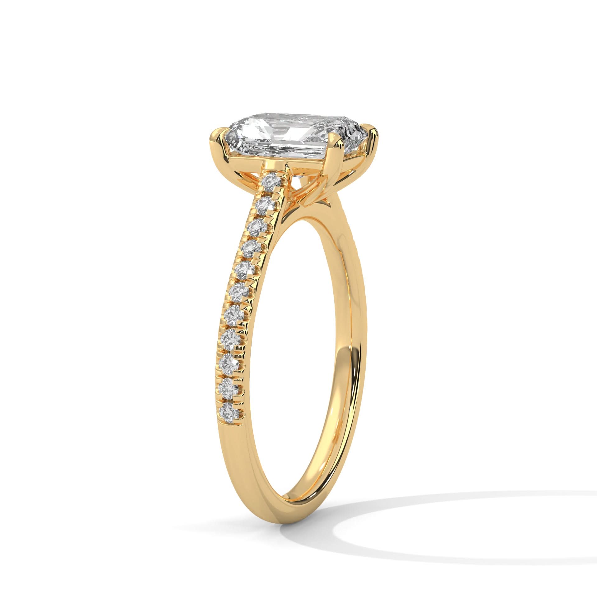 Gold ring with a large diamond and smaller diamonds on the band against a white background