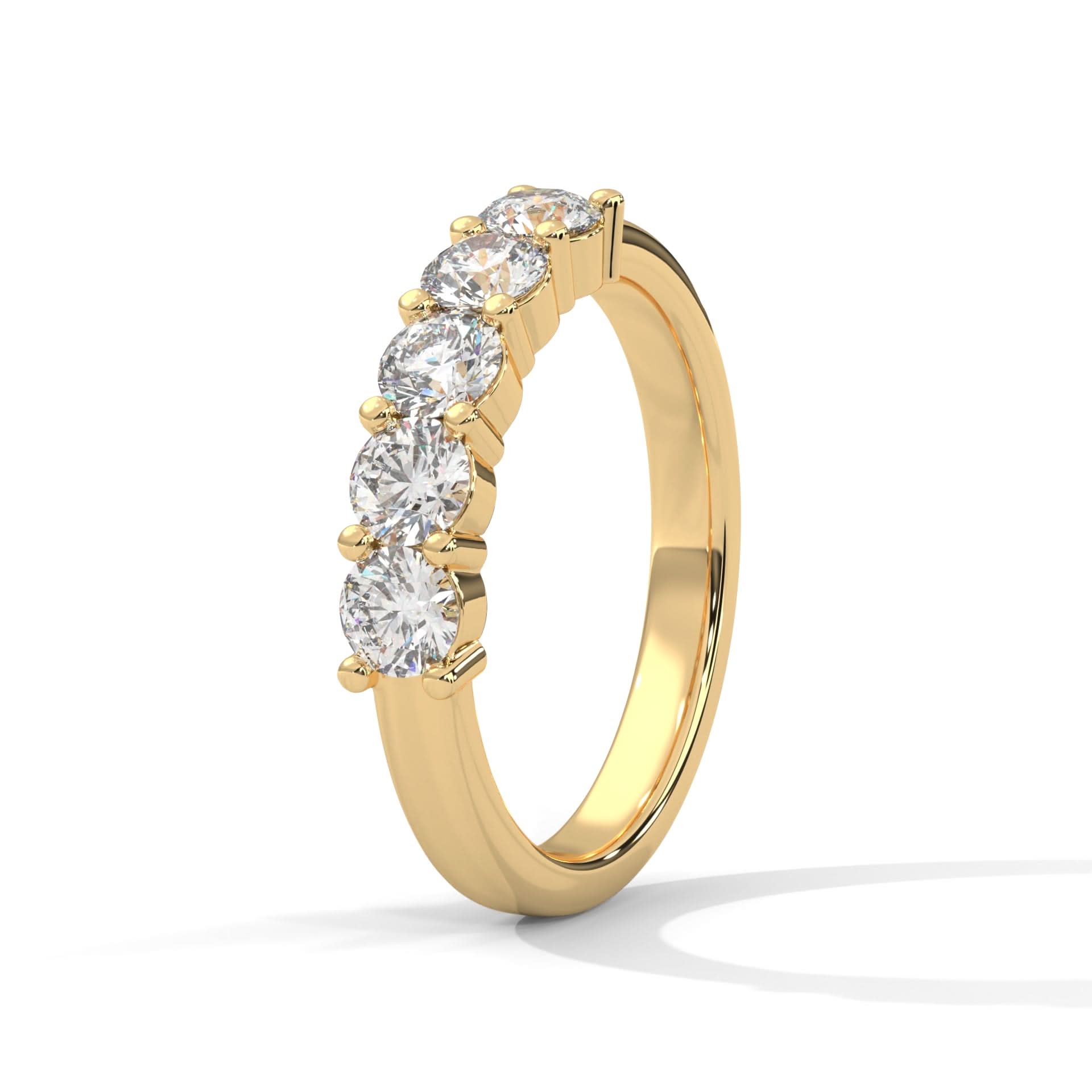 Gold ring with clear gemstones on a white background