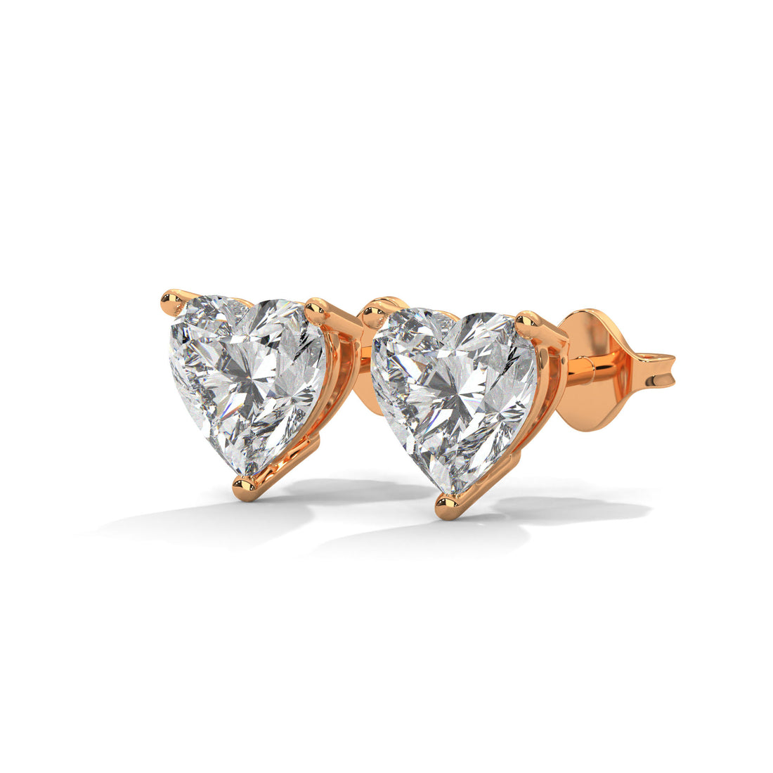 Heart-shaped diamond earrings with rose gold setting on a white background