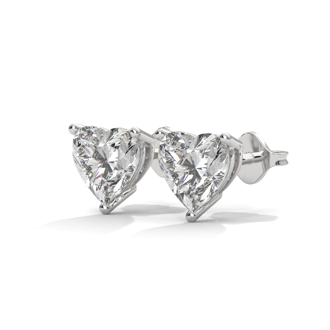 Heart-shaped diamond stud earrings on a white background