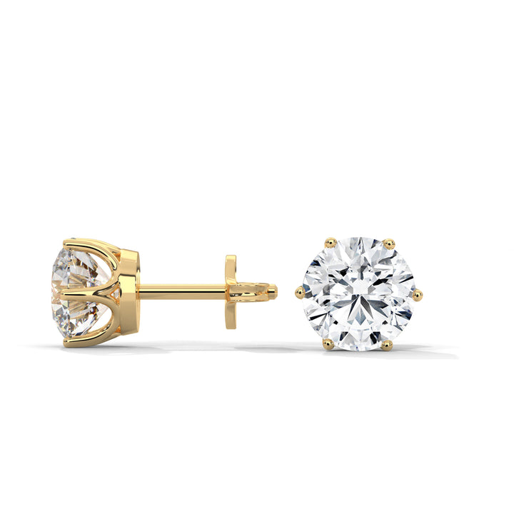 Gold stud earrings with clear gemstones on a white background