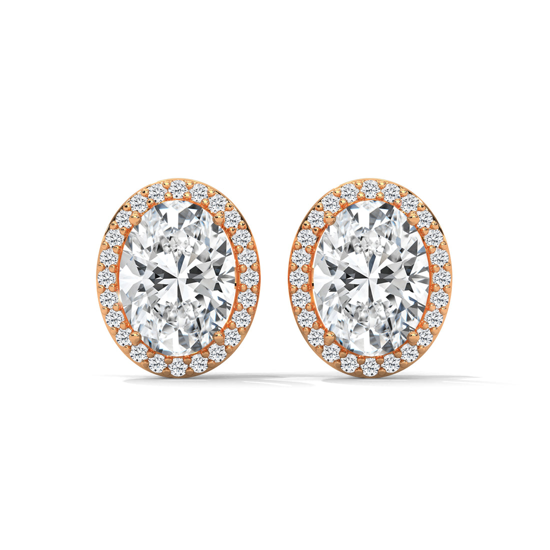 Pair of diamond earrings with rose gold setting on a white background