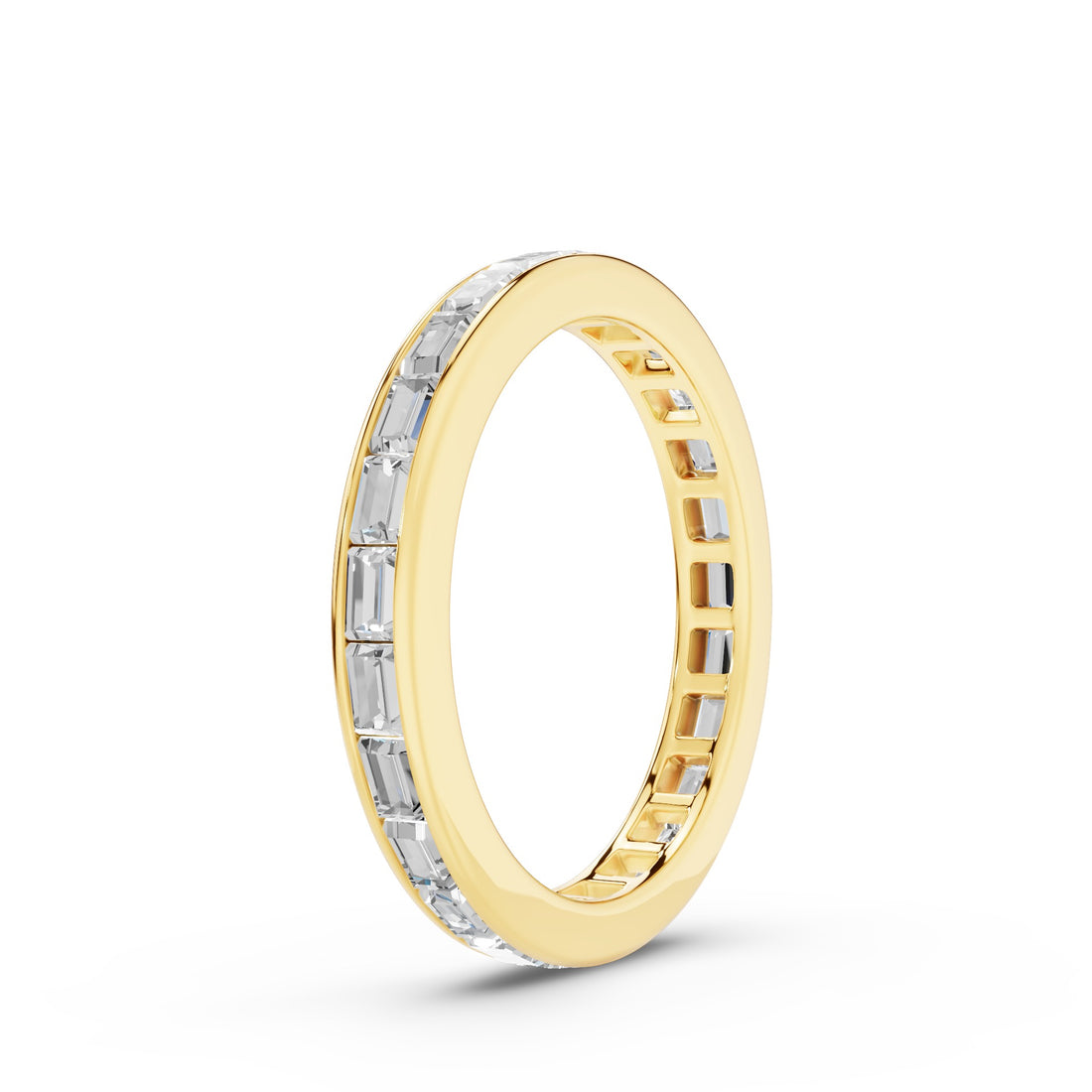 A yellow gold eternity ring featuring a channel-set row of baguette-cut clear stones on the outer band, shown against a clean white background.