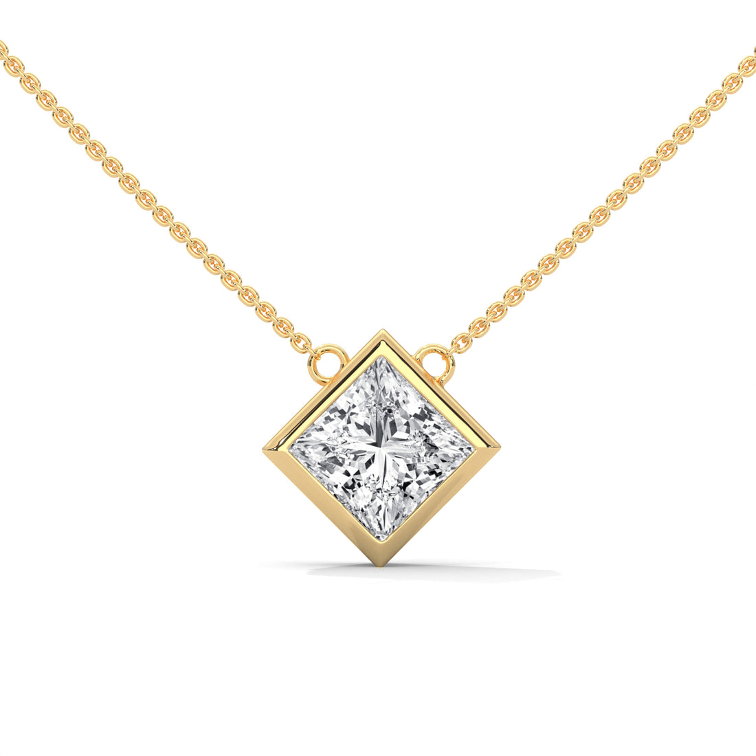 Gold necklace with princess cut diamond pendant on a white background