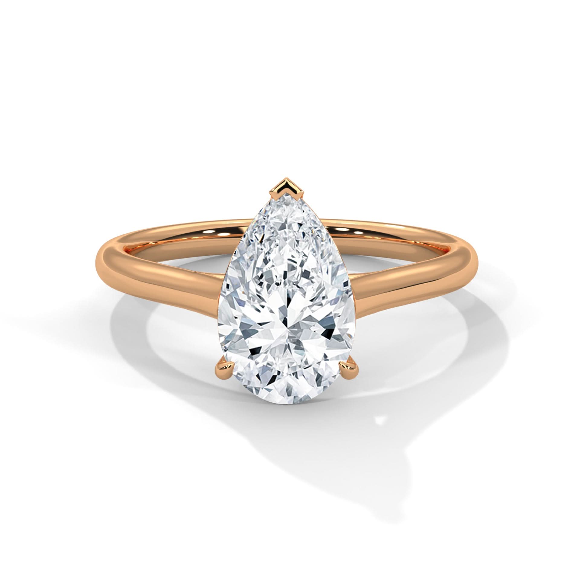 Rose gold ring with a pear-shaped diamond on a white background