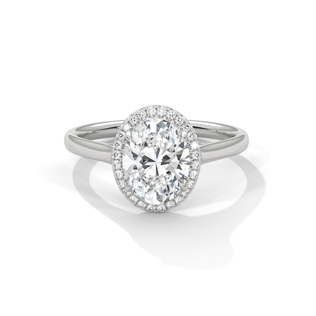 Diamond ring with a halo on a white background