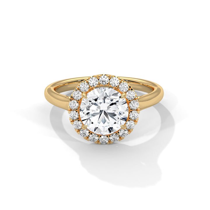 Gold ring with a large diamond and smaller diamonds around on a white background