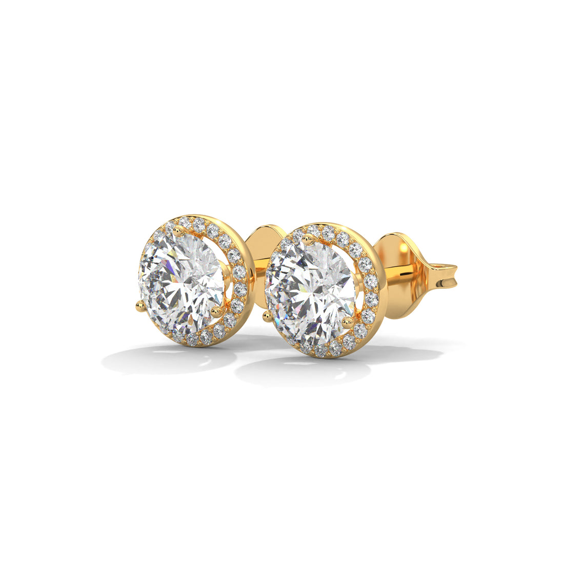 Gold earrings with large round gemstones on a white background