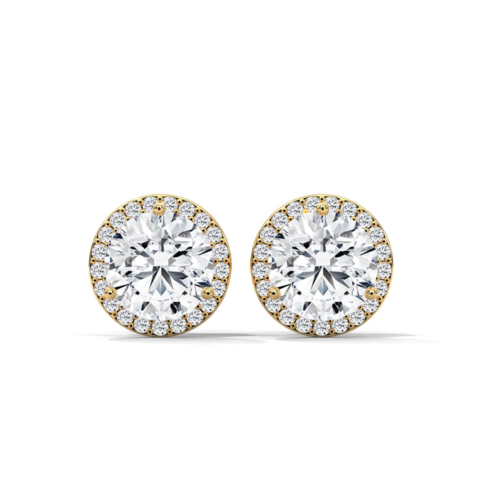 Pair of diamond earrings with gold accents on a white background