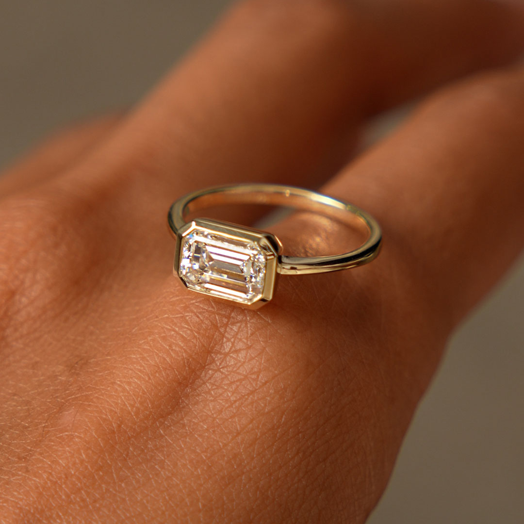 East West Emerald Cut Lab Grown Bezel Setting Engagement Ring