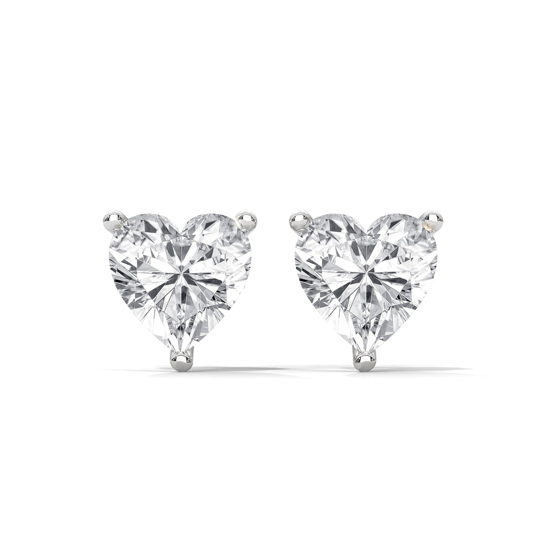 Heart-shaped diamond earrings on a white background