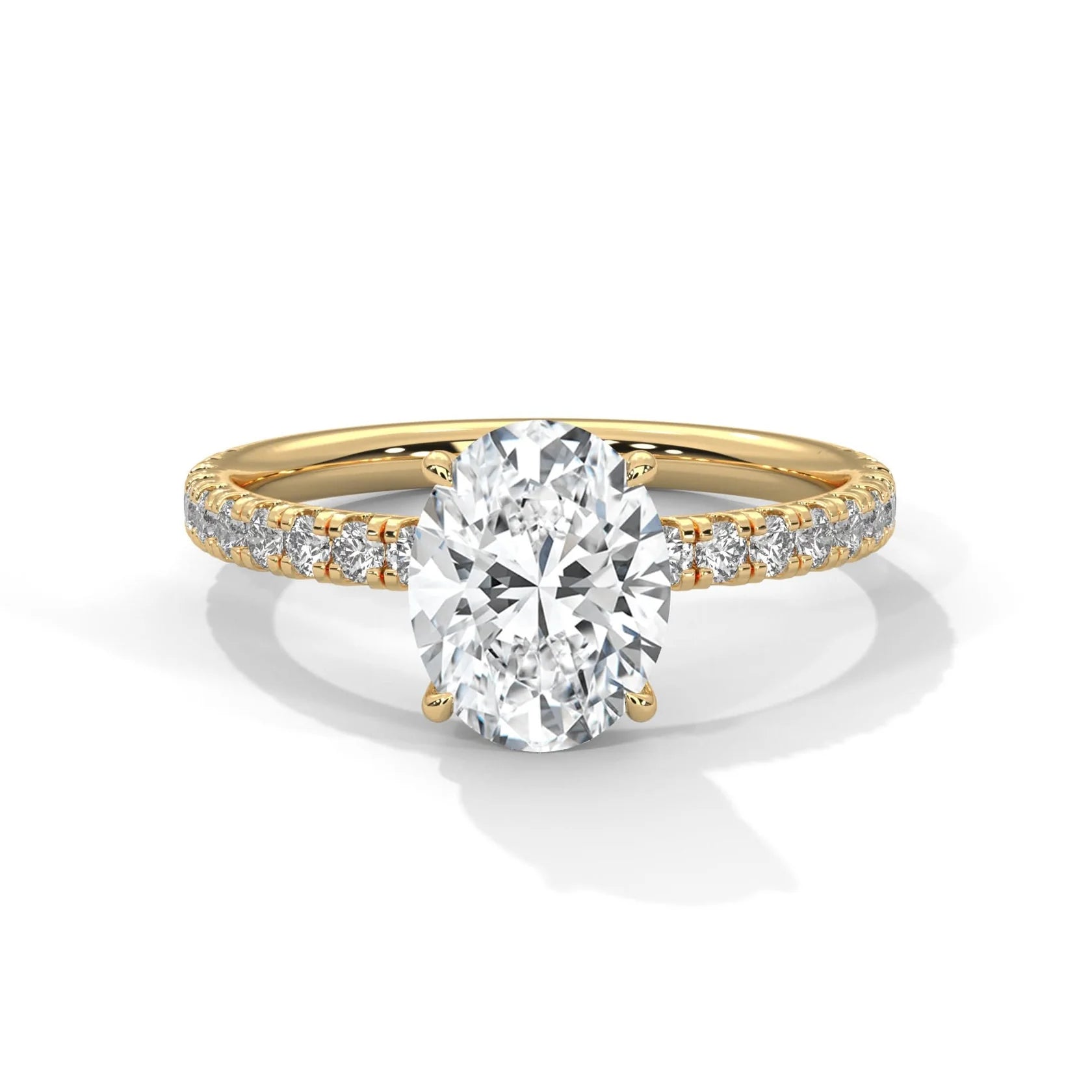 Gold ring with a large diamond and smaller diamonds on the band against a white background