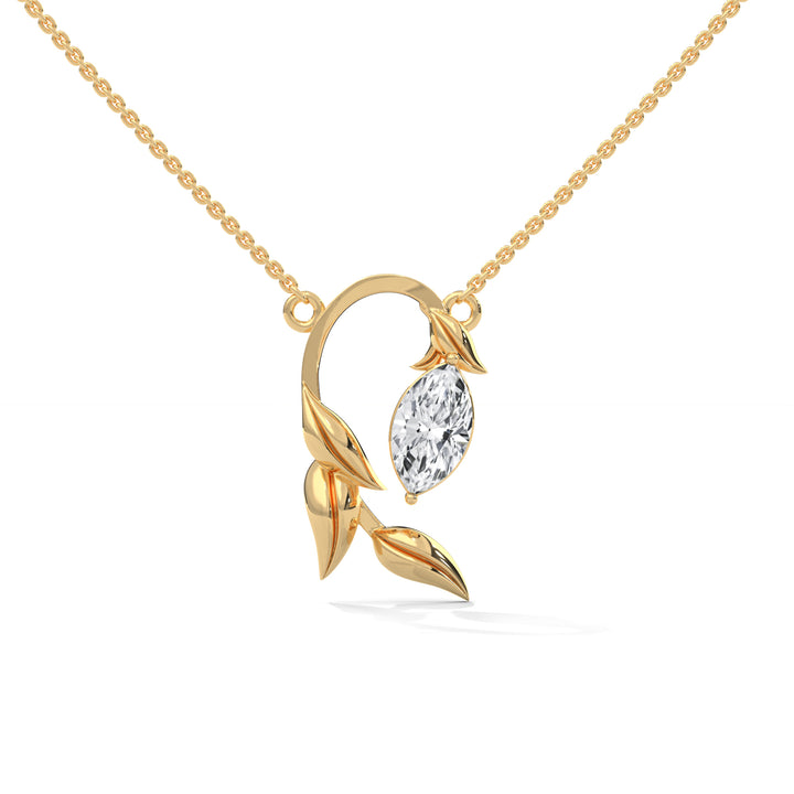 Gold necklace with a leaf-shaped pendant featuring a diamond on a white background