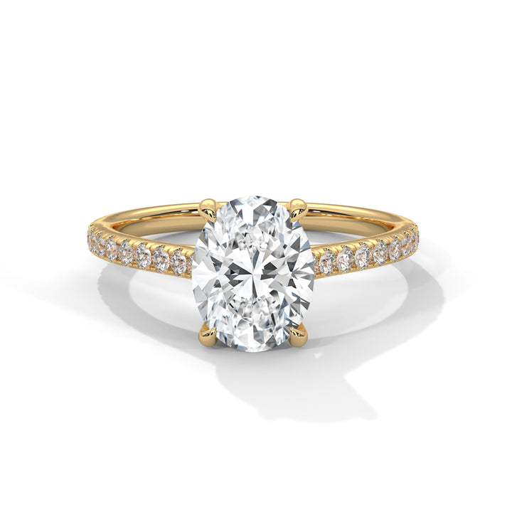 Gold ring with a large diamond and smaller diamonds on the band against a white background