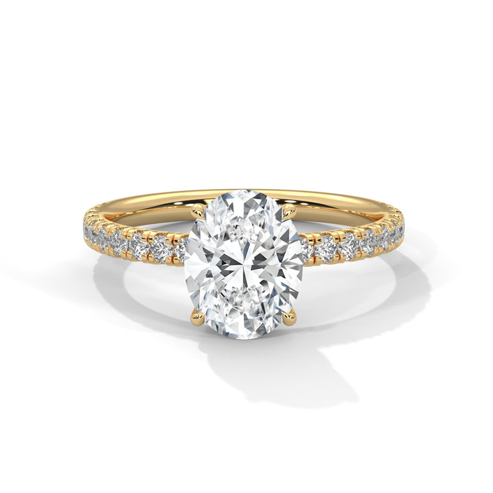 Gold ring with a large diamond and smaller diamonds on the band against a white background