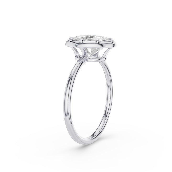 A classic solitaire engagement ring featuring a round brilliant-cut diamond set in a polished white gold or platinum band, shown on a clean white background.