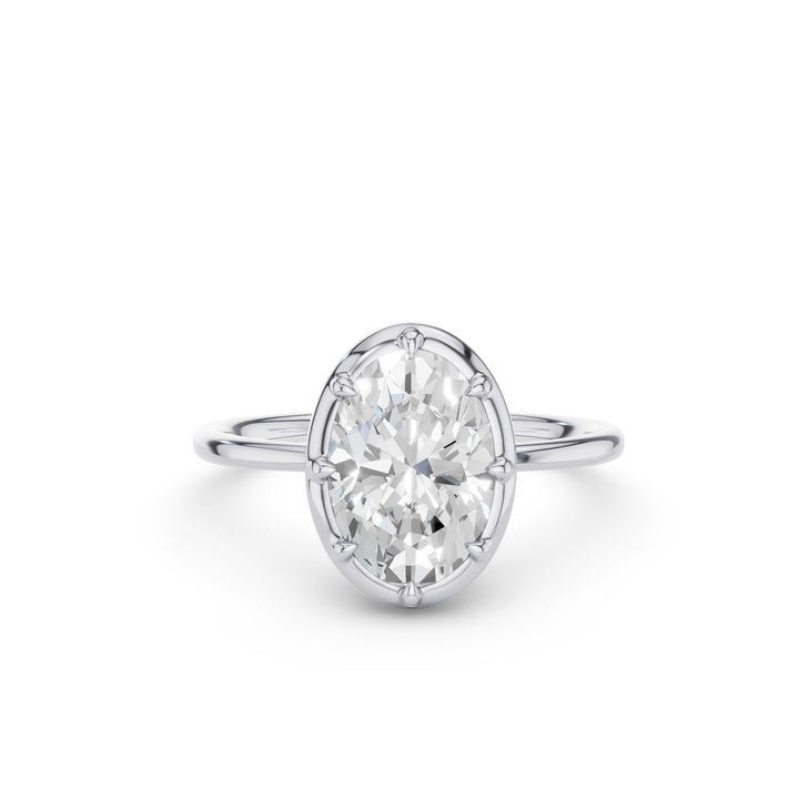 An oval-cut diamond engagement ring in a silver-colored four-prong setting on a plain white background.