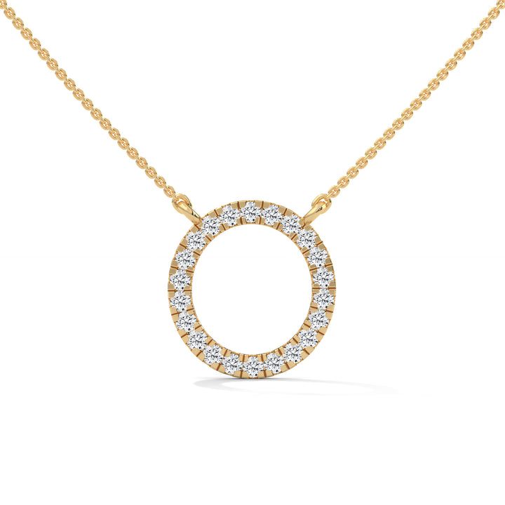 Gold necklace with a round diamond pendant on a white background
