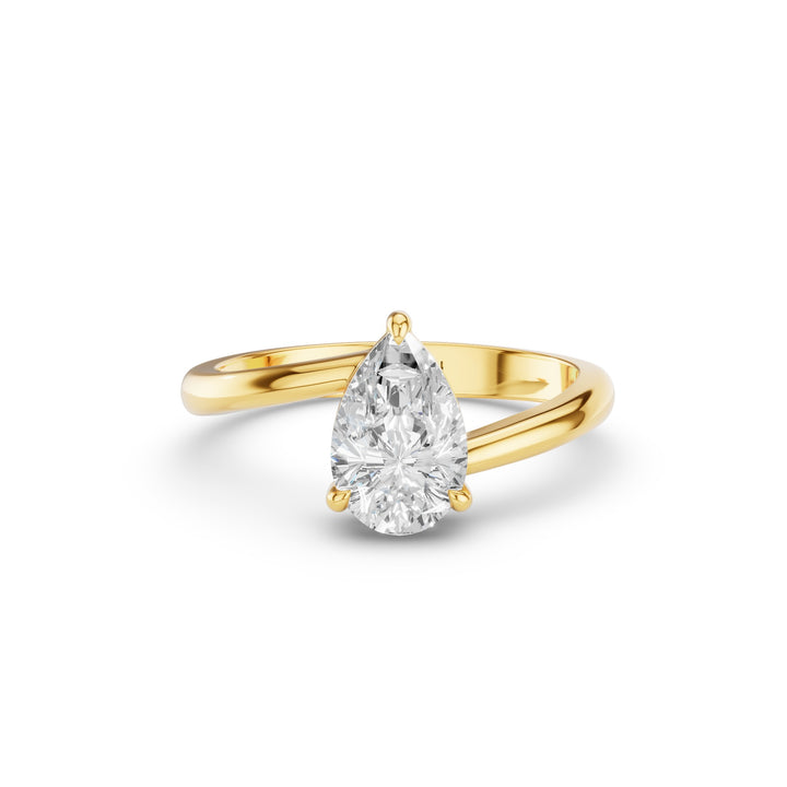 A pear-cut diamond engagement ring in a yellow gold band, shown on a clean white background with a soft shadow.