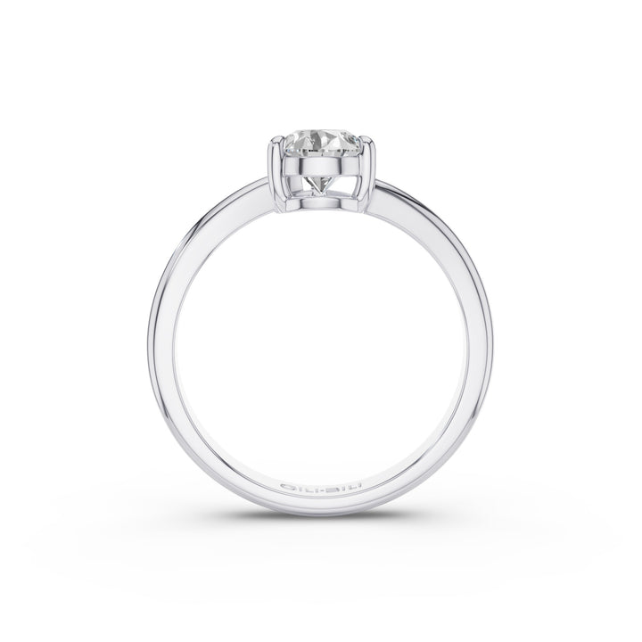 Gold ring with pear-shaped lab-grown diamond on a white background