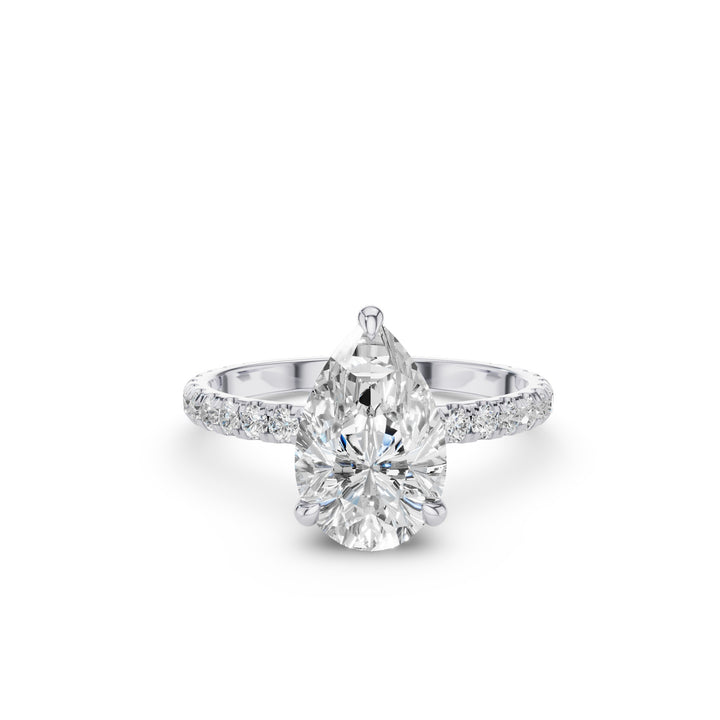 A pear-cut diamond engagement ring with a pavé-set diamond band in a silver-toned metal, shown on a clean white background.