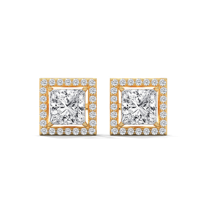 Pair of diamond earrings with gold frames on a white background