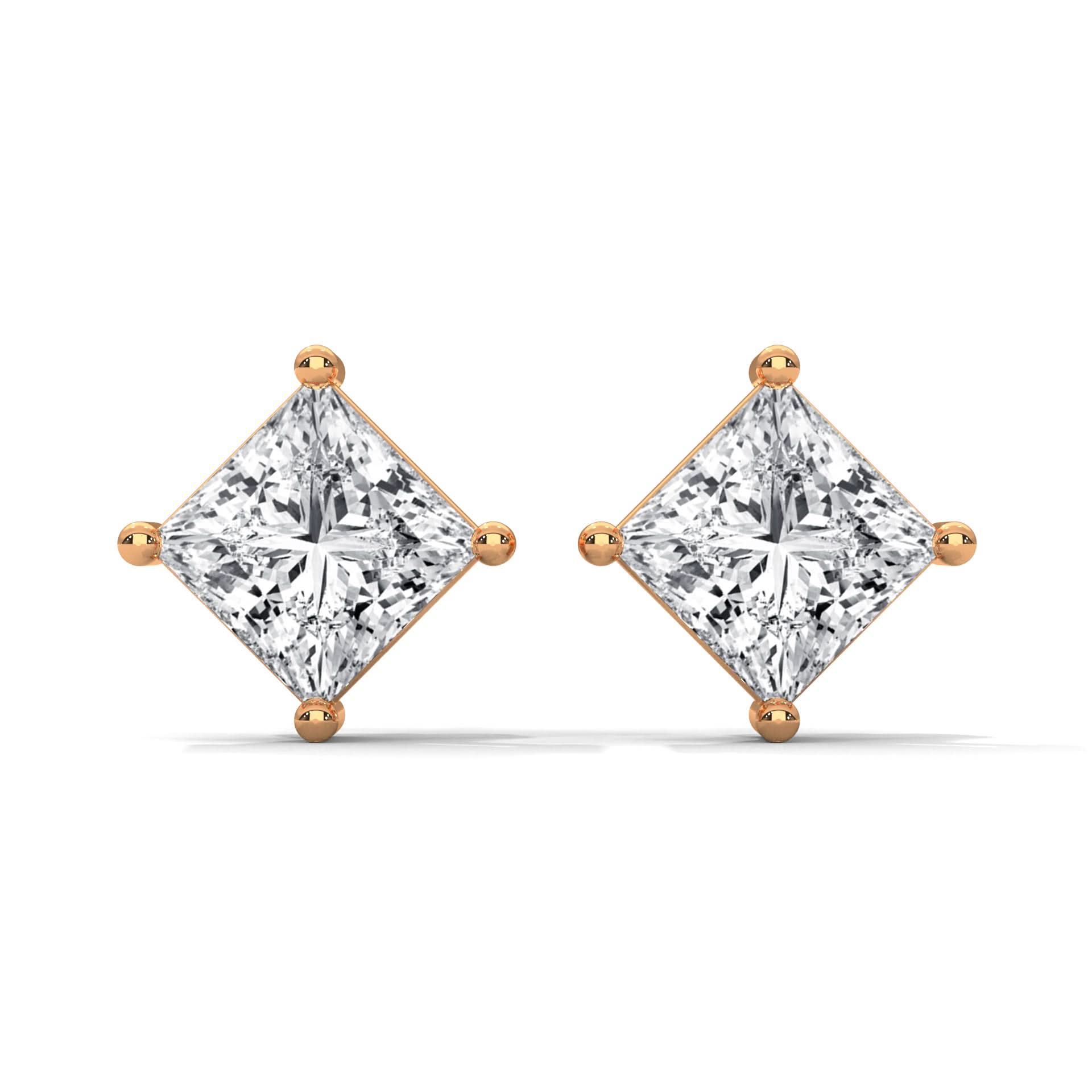 Pair of diamond earrings with rose gold prongs on a white background