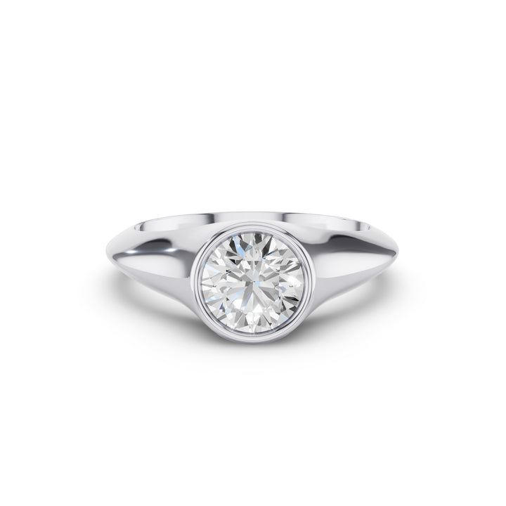 A classic solitaire engagement ring featuring a round brilliant-cut diamond set in a polished silver-colored metal band, shown against a plain white background.