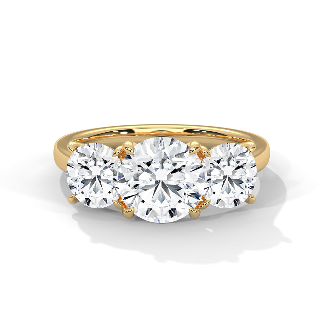 Gold ring with three diamonds on a white background