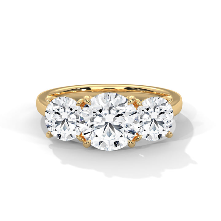 Gold ring with three diamonds on a white background