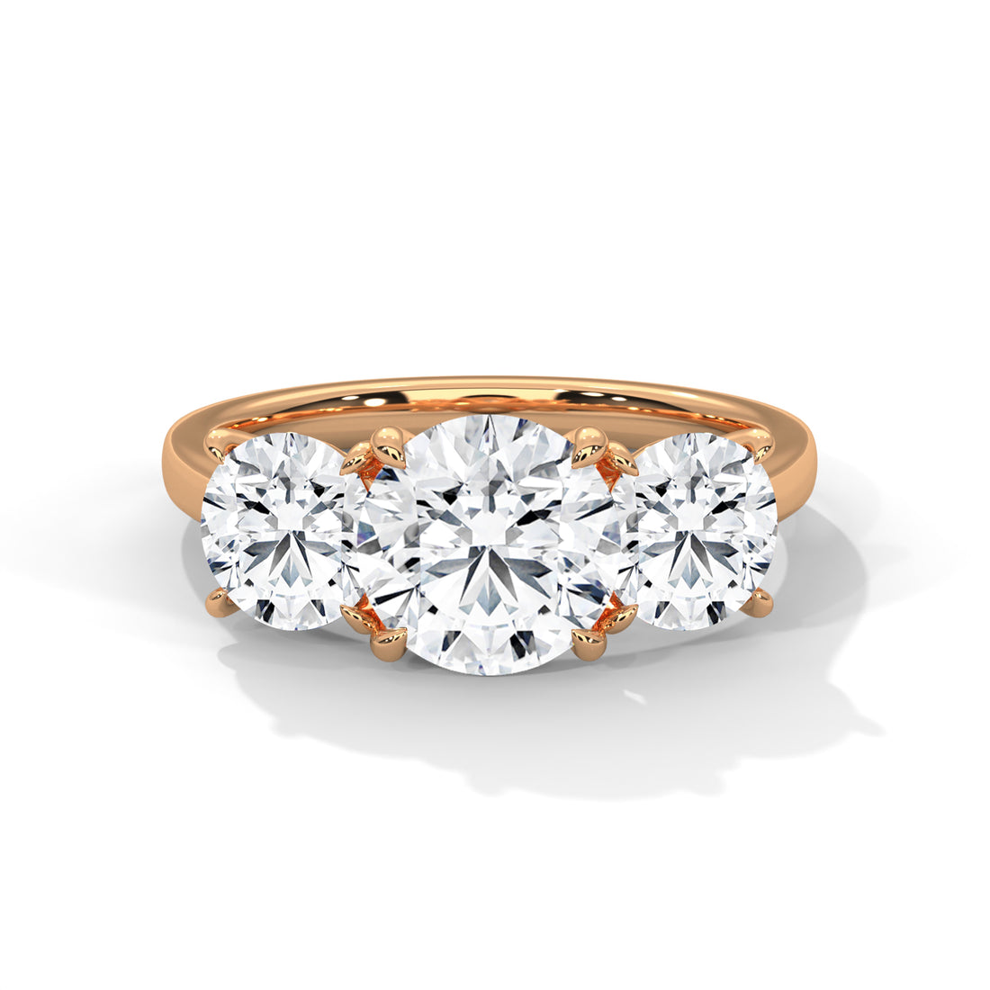 Rose gold ring with three diamonds on a white background
