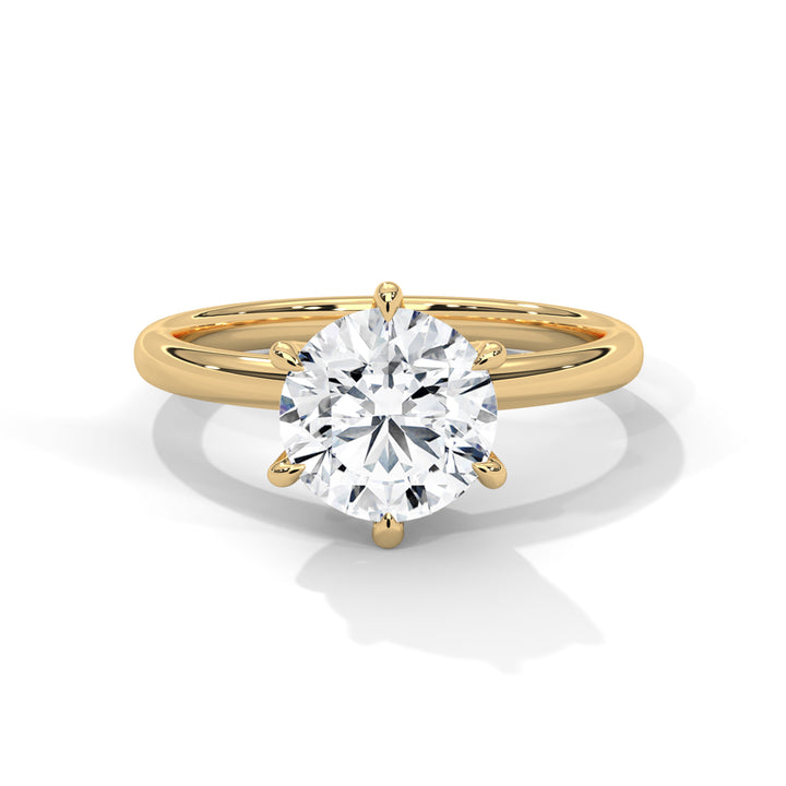 Gold ring with a large diamond on a white background