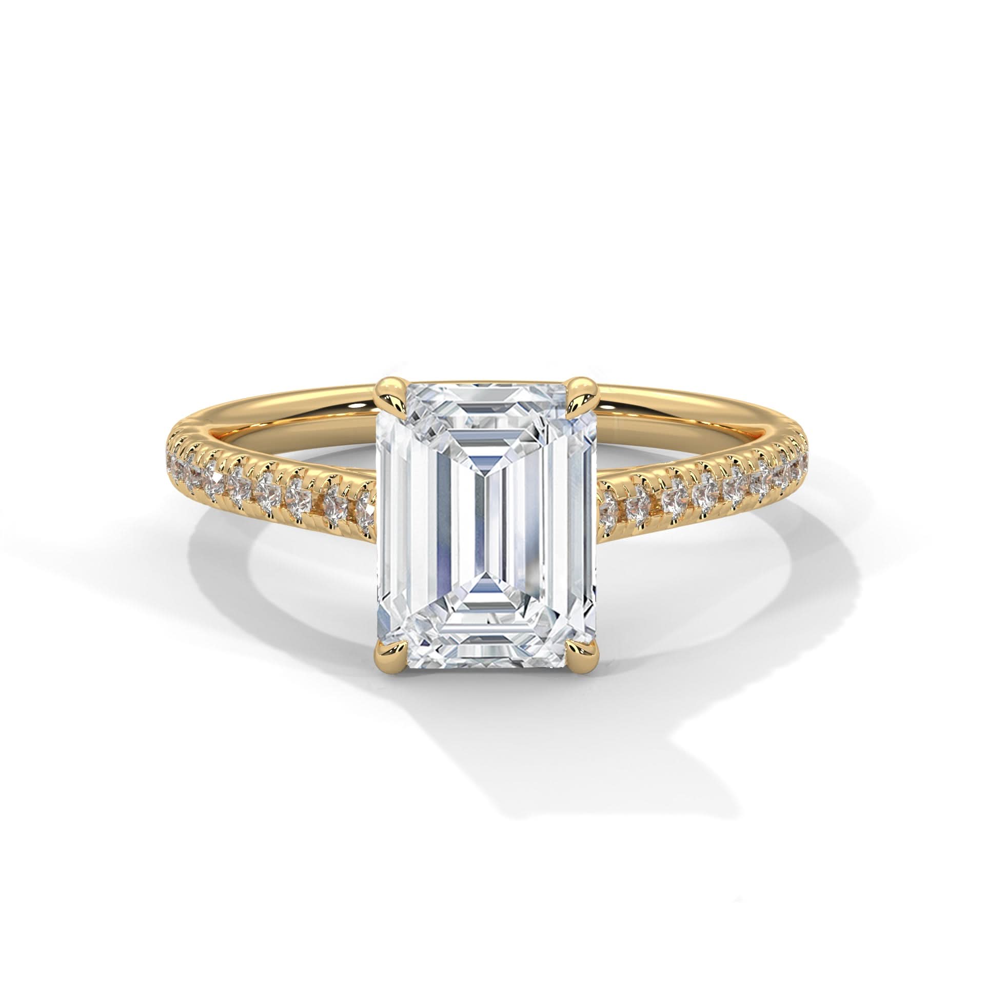 Gold ring with a large emerald-cut diamond and smaller diamonds on the band against a white background