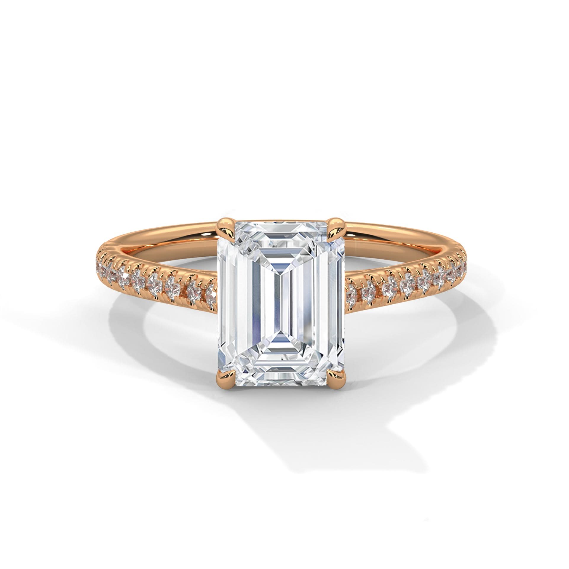 Rose gold ring with emerald-cut diamond and smaller diamonds on a white background