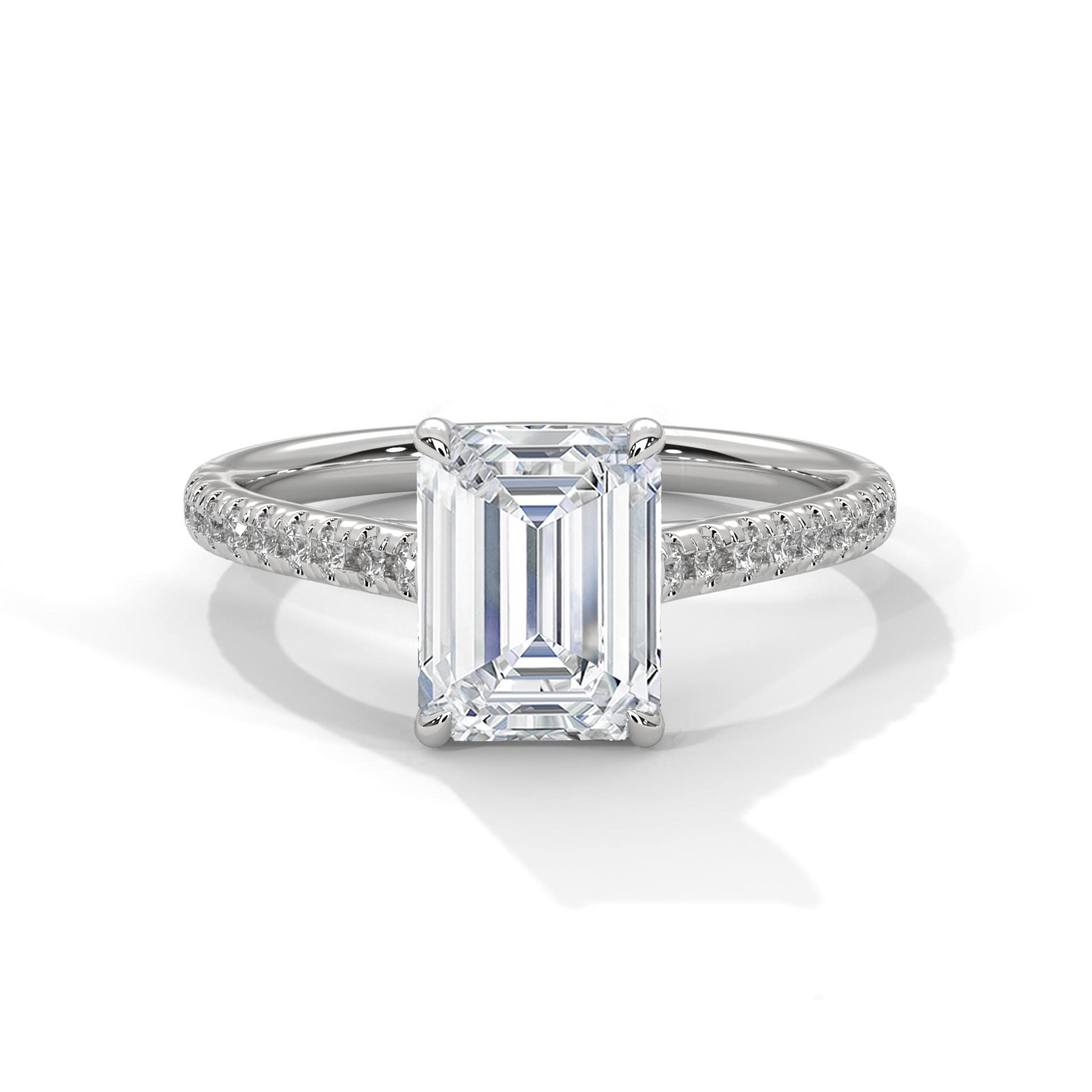 Diamond ring with emerald-cut center stone on a white background