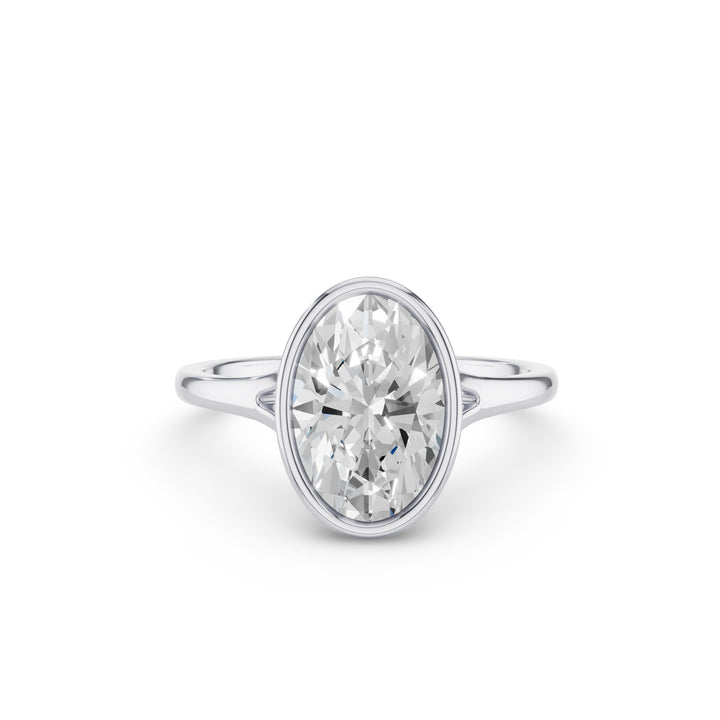 An oval-cut diamond engagement ring with a silver-colored band, shown on a clean white background.