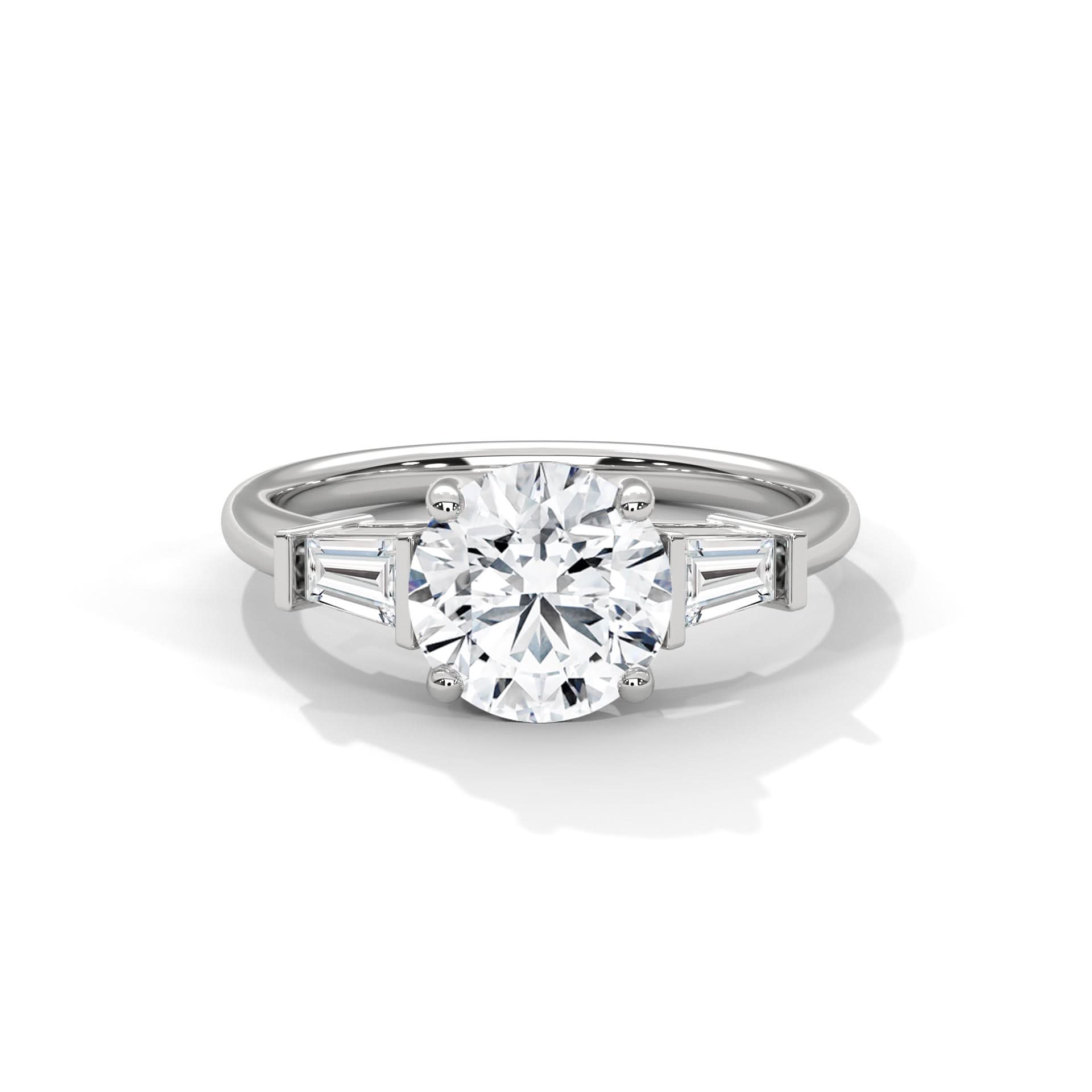 Diamond ring with a central round diamond and baguette side stones on a white background