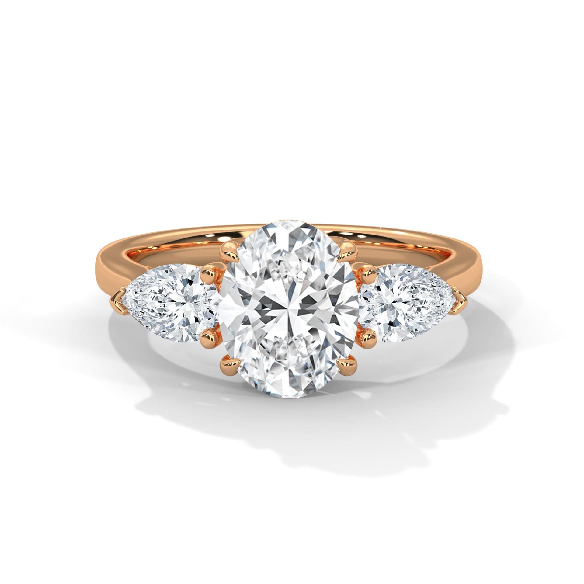 Rose gold ring with a large diamond and smaller pear-shaped diamonds on a white background